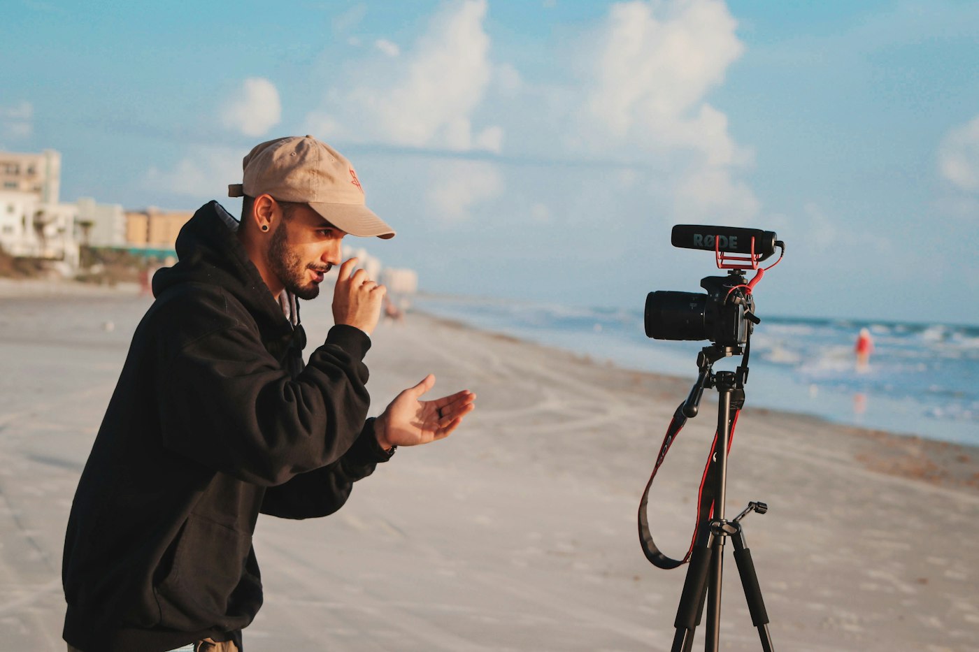 Creator filming himself on a beach